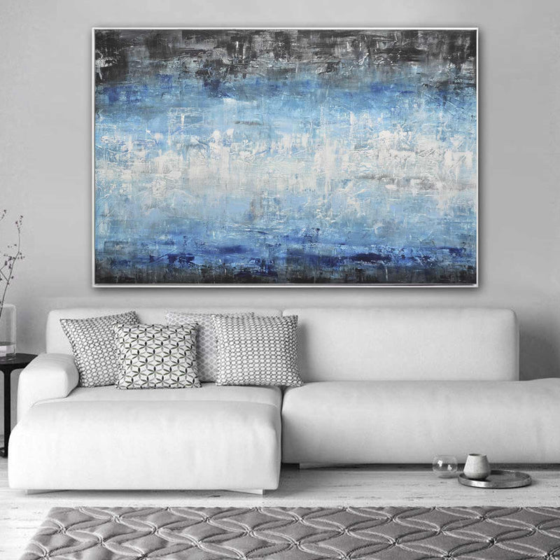 blue artwork above sofa