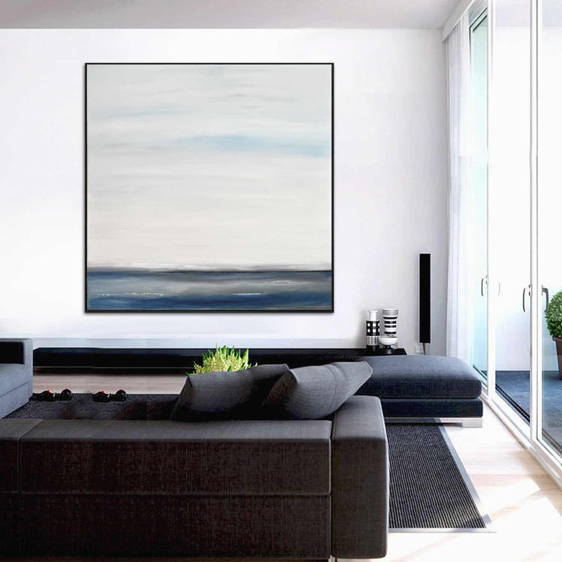 square minimalist landscape on wall above couch